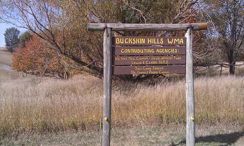 Brown wooden sign for Buckskin Hills WMA.