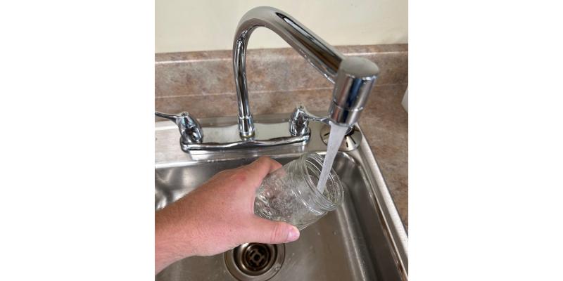 hand taking water sample